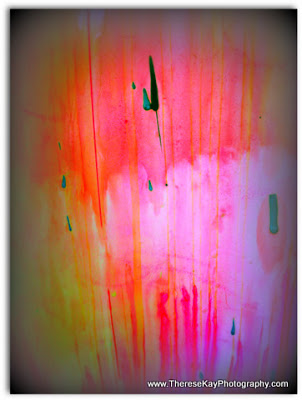 abstract photograph of paint splatters - pink, yellow, orange, green